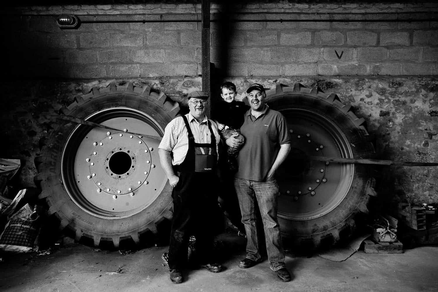 Grandad, son and grandson farmers photographed on the farm