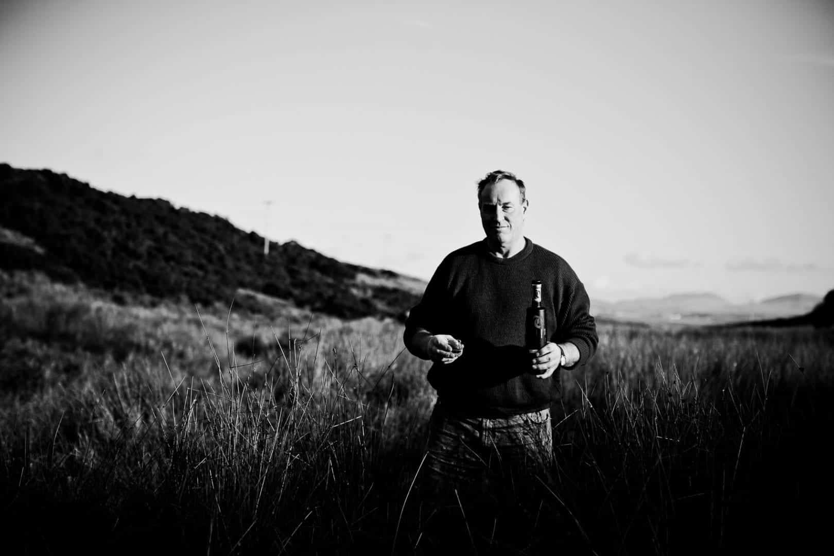 farmer james brown samples the water from his well on octomore farm